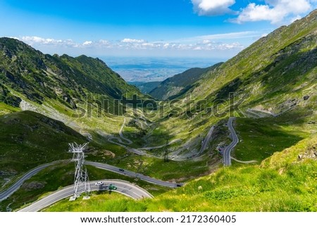 Beautiful mountain road with blue sky and high peaks. Transfagarasan highway, probably the best road in the world Royalty-Free Stock Photo #2172360405