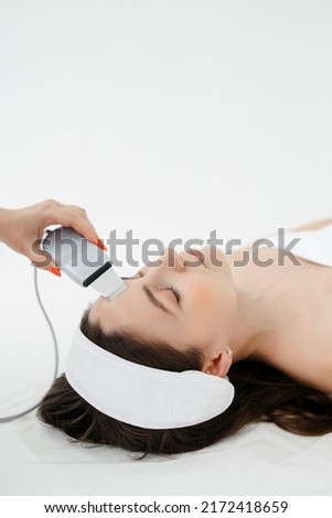 Apparatus Hydrofacial Facial Cavitation procedure. Procedure in a beauty salon. Electrical equipment for a spa. Apparatus for a medical patient. Acne removal. Royalty-Free Stock Photo #2172418659