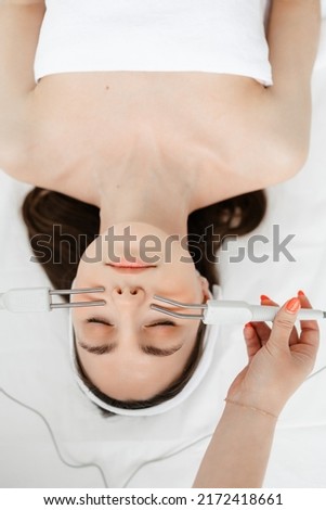 Hydrofacial apparatus facial cavitation procedure. Procedure in a beauty salon. Electrical equipment for a spa. Apparatus for a medical patient. Acne removal. Royalty-Free Stock Photo #2172418661