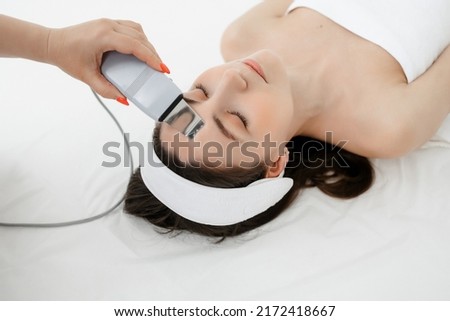 Apparatus Hydrofacial Facial Cavitation procedure. Procedure in a beauty salon. Electrical equipment for a spa. Apparatus for a medical patient. Acne removal. Royalty-Free Stock Photo #2172418667