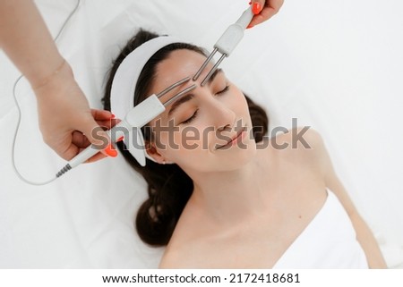 Hydrofacial apparatus facial cavitation procedure. Procedure in a beauty salon. Electrical equipment for a spa. Apparatus for a medical patient. Acne removal. Royalty-Free Stock Photo #2172418681