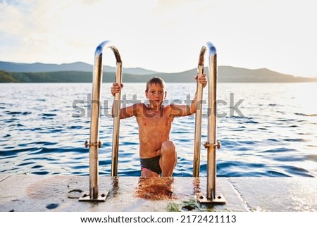 The boy comes out of the sea after bathing. High quality photo