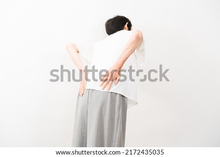 Health image of middle woman rubbing her lower back　