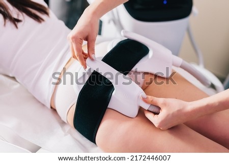 Woman getting ems treatment on buttocks to burn fat, build muscles and remove cellulite. Professional beauty salon Royalty-Free Stock Photo #2172446007