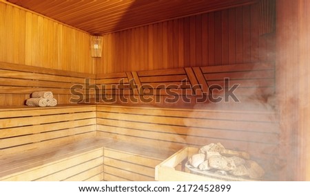 Interior of Finnish sauna, classic wooden sauna with hot steam. Russian bathroom. Relax in hot sauna with steam. Wooden interior baths, wooden benches and loungers accessories for sauna, spa complex. Royalty-Free Stock Photo #2172452899