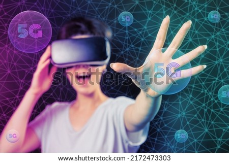 Portrait of caucasian happy amazement woman in VR glasses. Black background with neon grid and 5G spheres. Concept of metaverse, virtual reality and cyberspace.