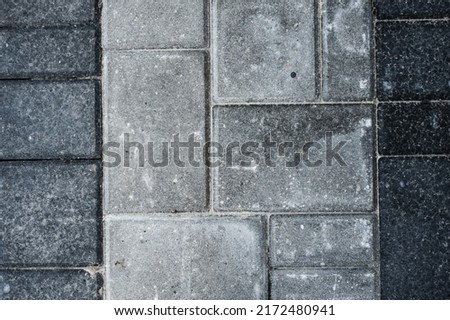 Laying gray concrete paving stones on house courtyard texture