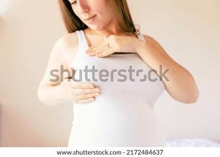 Breast exam cancer pregnancy woman check. Happy young pregnant woman self exam. Breast self exam. Health, medicine and beauty concept