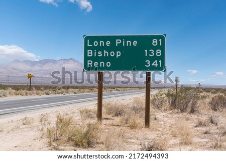 Highway sign to Lone Pine, Bishop and Reno on scenic US Route 14 in the Mojave desert area of California.