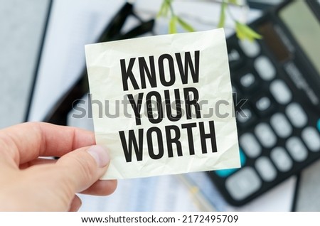 Businessman holding a card with text Know Your Worth.