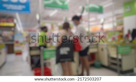 Checkout point, male and female payment at checkout, cashier in shopping mall for blur background