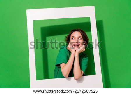 Portrait of minded pretty lady hands touch cheeks look empty space isolated on green color background