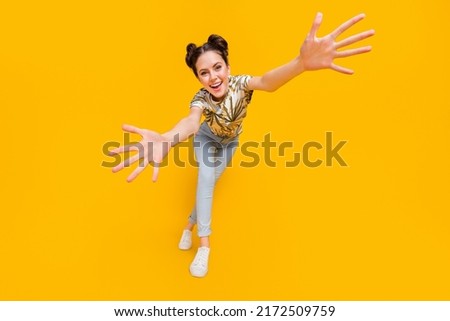 Photo of sweet pretty lady dressed print t-shirt dancing open arms catching you isolated yellow color background