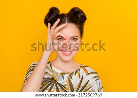 Photo of tricky funny woman wear print t-shirt showing okey cover eye isolated yellow color background