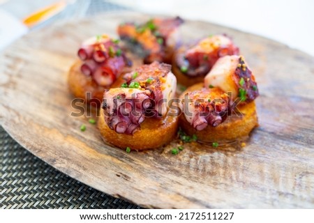 Spanish starter dish in fish restaurant in Getaria, grilled octopus with roasted potatoes and paprika, Basque Country, Spain Royalty-Free Stock Photo #2172511227