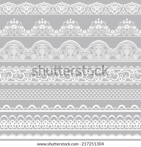 Set of white lace borders isolated on gray background