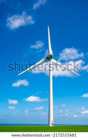View on modern wind mills, green grain fields and blue Atlantic ocean in agricultural region Pays de Caux in Normandy, France in summer Royalty-Free Stock Photo #2172515681