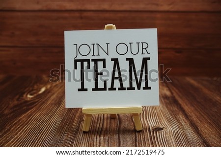 Join Our Team text on paper card on wooden background