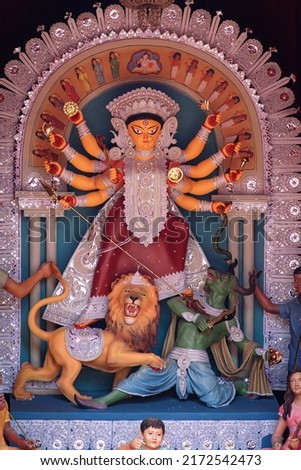 Idol of Goddess Devi Durga at a decorated puja pandal in Kolkata, West Bengal, India. Durga Puja is a famous and major religious festival of Hinduism that is celebrated throughout the world. Royalty-Free Stock Photo #2172542473