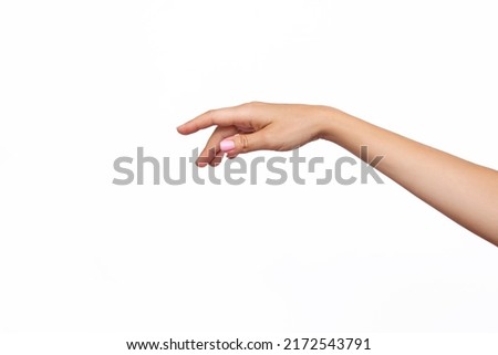 A caucasian female outstretched hand makes a gesture seems to click, point or touch something with the index finger isolated on a white background. Mockup with empty copy space for a intended object