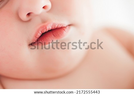 Closeup picture of baby`s mouth. Infant`s face. Kid is sleeping.