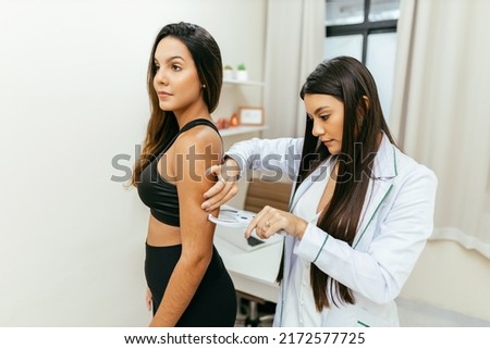 Sports nutritionist consulting patient at her clinic Royalty-Free Stock Photo #2172577725
