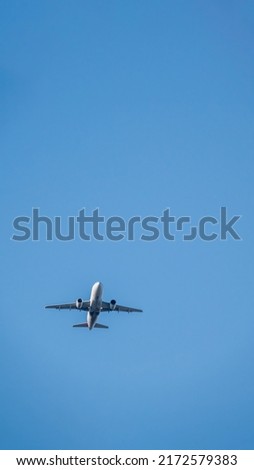 Minimalist terrestrial view of the underside of a commerical jet airliner in mid air on a sunny afternoon over Washington DC Royalty-Free Stock Photo #2172579383