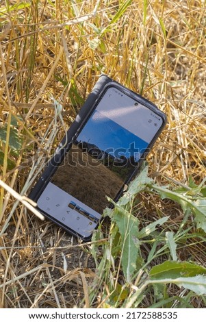 Mobile phone with a picture on the grass
