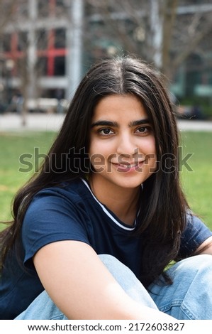 Closeup portrait of young girl looking at camera smiling