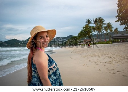 Selective focus. happy woman on the beach. Young woman on vacation at the beach. Woman with beach hat