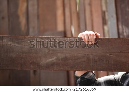 Carpenter working on woodworking machines in carpentry shop. he works in a carpentry shop or warehouse 