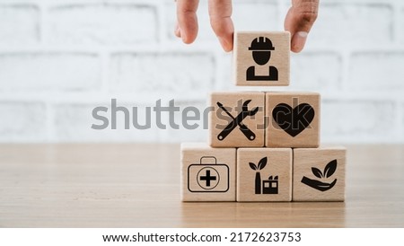 Health safety environment HSE education industry Concept, Man hand holding wooden cube block with Health safety environment icon with copy space.