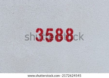 Red Number 3588 on the white wall. Spray paint.
