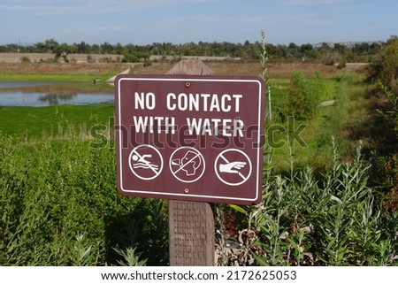 Brown sign warning to have No Contact with Water. Pictograms for no drinking or touching water. Reclaimed recycled water.
