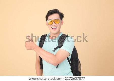Energetic happy young Asian handsome man, isolated on background