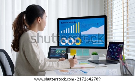 Asia young business woman sit busy at home office desk work code on desktop reskill upskill for job career remote self test IT deep tech ai design skill online html text for cyber security workforce. Royalty-Free Stock Photo #2172642789