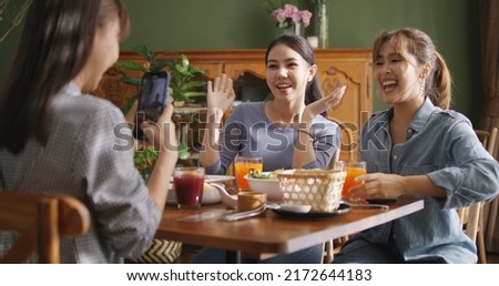 Asia teen girl vlogger group show share talk viral live vlog fun laugh smile look camera in  reel   mobile app Gen z youth people enjoy happy meal food at reopen retail cafe table Royalty-Free Stock Photo #2172644183