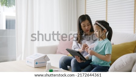 Telehealth telemedicine care mobile app exam visit service asia people. Worry mom and sick kid girl ask doctor in video call talk VoIP clinic self cure with cold flu Rx box pill at sofa home isolate. Royalty-Free Stock Photo #2172644361
