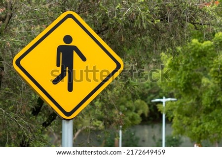 Pedestrian sign. Pedestrian crossing sign, Yellow man walking road sign. Royalty-Free Stock Photo #2172649459