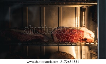 Big piece of red dry aged beef, rib eye at a butcher, steak in a glass store Royalty-Free Stock Photo #2172654831