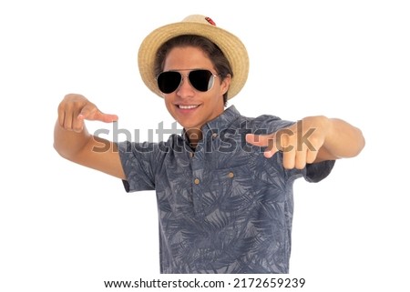young man with hat and sunglasses in a funny attitude. Concept of tourism and summer. 
