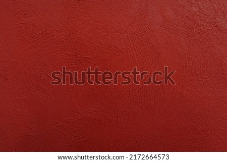 Crimson colored wall background with textures of different shades of crimson red.