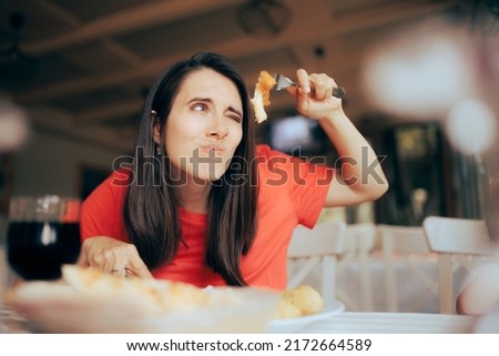 
Exigent Woman Over Analyzing Food Course in a Restaurant. Worried customer suffering from orthorexia worried about cholesterol
 Royalty-Free Stock Photo #2172664589