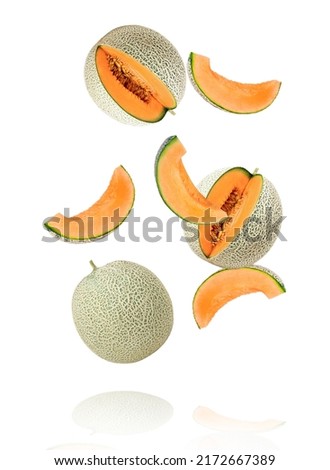 Japanese melon or cantaloupe (Cucumis melo) with cut slice flying in the air isolated on white background. Royalty-Free Stock Photo #2172667389