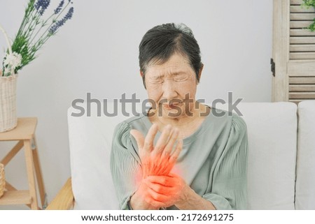 Asian senior woman having the joint pain at home
