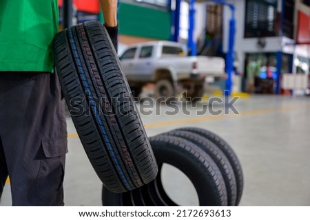 change tire In the process of bringing 4 new tires in stock to be replaced at a service center or auto repair shop for the automotive industry.