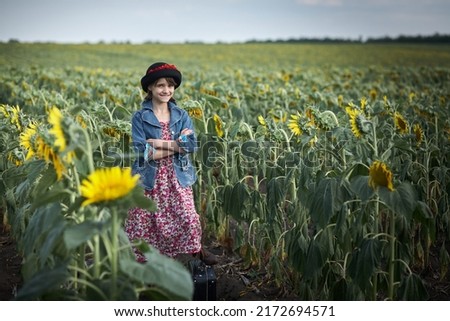 Cute girl in a sunflower field.