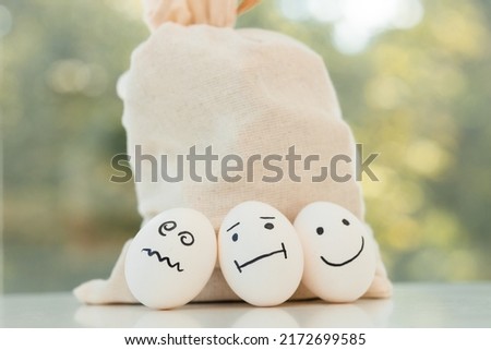 Eggs with funny faces on brown sackcloth