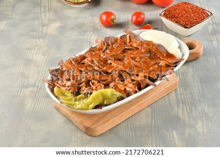 traditional turkish iskender kebab on a wooden surface at restaurant