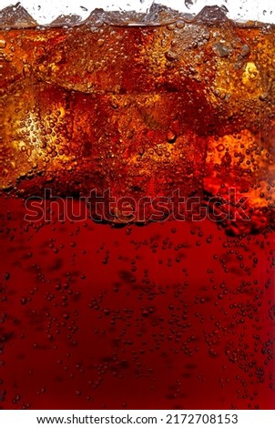 Macro photography of a glass of cola soft drink with ice. Royalty-Free Stock Photo #2172708153